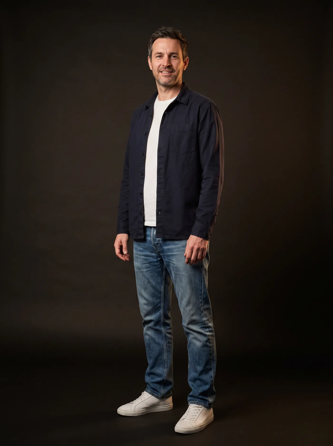 A man wearing an overshirt, T-shirt, jeans and sneakers from four brands